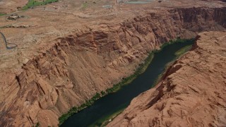 AX131_154E - 5.5K aerial stock footage of flying over canyon and the Colorado River, Glen Canyon, Arizona