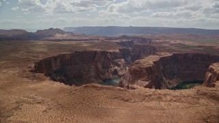 AX131_161E - 5.5K aerial stock footage of flying by Horseshoe Bend, then away from Colorado River, Glen Canyon, Arizona