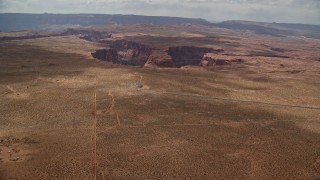 AX131_163E - 5.5K aerial stock footage approach and tilt to bird's eye view of Horseshoe Bend and Colorado River, Glen Canyon, Arizona