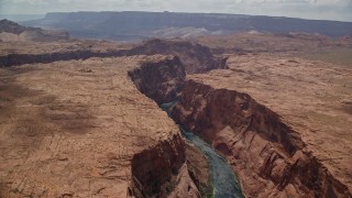 AX131_168 - 5.5K aerial stock footage of flying by Colorado River flowing through Glen Canyon, Arizona