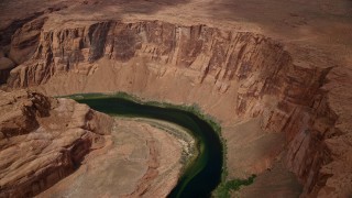 AX131_169E - 5.5K aerial stock footage of flying away from Horseshoe Bend and the Colorado River in Glen Canyon, Arizona