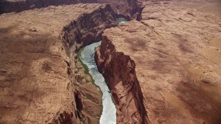 AX131_181E - 5.5K aerial stock footage of flying by a bend in the Colorado River at the bottom of Glen Canyon, Arizona