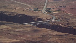 AX131_196E - 5.5K aerial stock footage of a view of Navajo Bridge spanning Marble Canyon, Glen Canyon National Recreation Area, Utah, Arizona