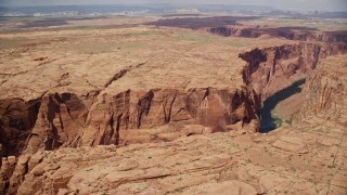 AX131_206 - 5.5K aerial stock footage of passing the Colorado River running through Glen Canyon, Arizona
