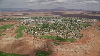 AX131_222 - 5.5K aerial stock footage of approaching a small desert town, Page, Arizona
