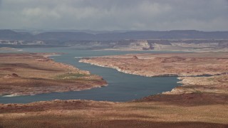 AX131_227 - 5.5K aerial stock footage of passing Lake Powell, mesas in the background, Utah, Arizona