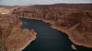 AX131_232E - 5.5K aerial stock footage of flying over Lake Powell canyons in Navajo Canyon, Arizona