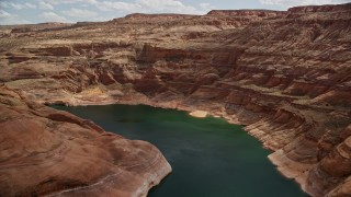 AX131_239E - 5.5K aerial stock footage of flying over canyon cliffs and Lake Powell rivers and coves, in Navajo Canyon, Arizona