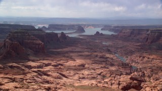 AX132_012 - 5.5K stock footage aerial video of passing by buttes leading to Lake Powell, Navajo Nation Reservation, Arizona