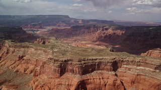 AX132_020E - 5.5K stock footage video of a wide view of dry riverbed in a canyon, Navajo Nation Reservation, Utah