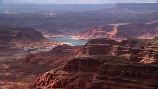 AX132_025 - 5.5K stock footage aerial video of flying by Lake Powell and mesas, Navajo Nation Reservation, Utah