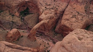 AX132_034E - 5.5K aerial stock footage of a natural stone bridge, Rainbow Bridge National Monument, Utah