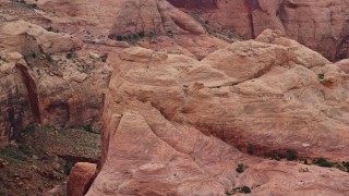 AX132_043E - 5.5K aerial stock footage flyby rock formation, reveal stone arch, Rainbow Bridge National Monument, Utah
