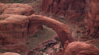 AX132_048 - 5.5K stock footage aerial video of a view of a natural stone arch at Rainbow Bridge National Monument, Utah