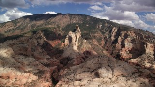 AX132_051 - 5.5K stock footage aerial video of flying by tall mountain peak, Navajo Mountain, Utah