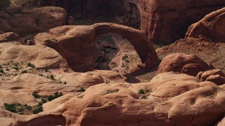 AX132_060 - 5.5K aerial stock footage of a close-up view of a natural stone bridge, Rainbow Bridge National Monument, Utah