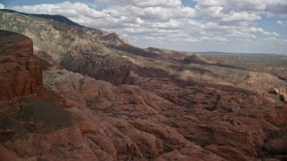 AX132_067E - 5.5K aerial stock footage of approaching rock formations, mountain peak and slopes, Navajo Mountain, Utah