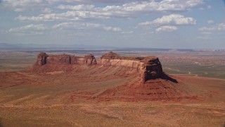 AX132_126E - 5.5K aerial stock footage of Train Rock mesa and desert valley, Navajo Nation Reservation, Arizona, Utah