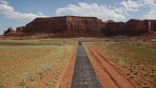 AX132_136 - 5.5K aerial stock footage of approaching airport by Rock Door Mesa, Monument Valley Airport, Utah