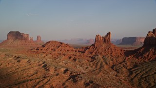 AX133_008 - 5.5K aerial stock footage of Setting Hen Butte in Monument Valley, Utah, Arizona, sunset