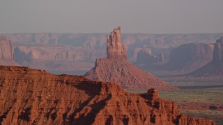 AX133_009E - 5.5K aerial stock footage of Big Indian Butte in Monument Valley, Utah, Arizona, sunset