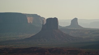 AX133_021 - 5.5K aerial stock footage of flying by West Mitten Butte, Mitchell Butte in Monument Valley, Utah, Arizona, twilight
