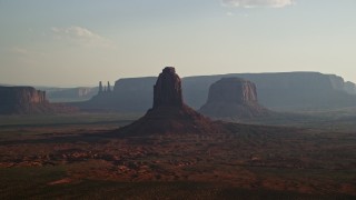 AX133_024E - 5.5K aerial stock footage flyby buttes, mesas, desert valley, Monument Valley, Utah, Arizona, twilight
