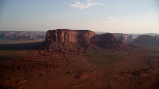 AX133_030 - 5.5K stock footage aerial video of flying by Spearhead Mesa, Monument Valley, Utah, Arizona, sunset