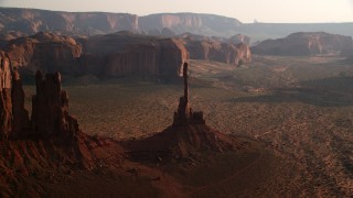 AX133_038 - 5.5K stock footage aerial video of flying by Totem Pole Butte, Monument Valley, Utah, Arizona, twilight