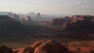 AX133_048 - 5.5K stock footage aerial video of passing by buttes and mesas in Monument Valley, Utah, Arizona, twilight