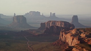 AX133_063E - 5.5K aerial stock footage of flying by Merrick Butte, Elephant Butte in Monument Valley, Utah, Arizona, twilight