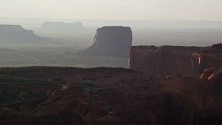 AX133_073E - 5.5K aerial stock footage of approaching Mitchell Butte in Monument Valley, Utah, Arizona, twilight