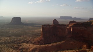AX133_075 - 5.5K aerial stock footage of flying by mesa, approaching buttes in Monument Valley, Utah, Arizona, twilight