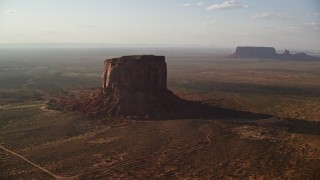 AX133_078E - 5.5K aerial stock footage of an orbit of Mitchell Butte, Monument Valley, Utah, Arizona, sunset