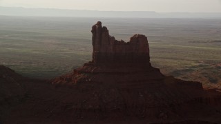 AX133_092 - 5.5K aerial stock footage of Setting Hen Butte in Monument Valley, Utah, Arizona, twilight