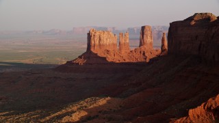 AX133_095E - 5.5K aerial stock footage of tall buttes in Monument Valley, Utah, Arizona, twilight