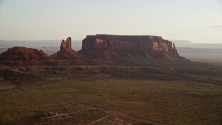 AX133_125 - 5.5K aerial stock footage of Setting Hen Butte and Eagle Mesa, Monument Valley, Utah, Arizona, twilight