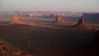 AX133_137 - 5.5K aerial stock footage of a wide view of several buttes in Monument Valley, Utah, Arizona, twilight