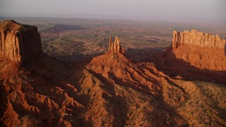 AX133_141E - 5.5K aerial stock footage bird's eye view of King on His Throne Butte, Monument Valley, Utah, Arizona, sunset