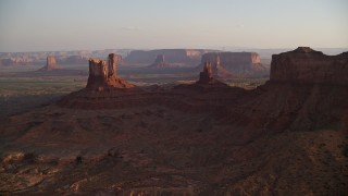 AX133_144E - 5.5K aerial stock footage of several buttes in Monument Valley, Utah, Arizona, sunset