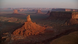 AX133_155E - 5.5K aerial stock footage of a wide view of buttes and mesas in famous Monument Valley, Utah, Arizona, sunset