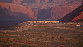 AX133_160 - 5.5K stock footage aerial video of flying by The View Hotel, Monument Valley, Utah, Arizona, sunset