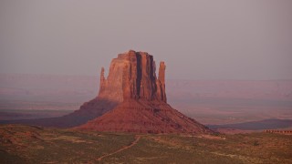 AX133_167E - 5.5K aerial stock footage flyby West Mitten Butte and East Mitten Butte, Monument Valley, Utah, Arizona, sunset