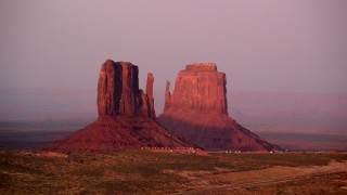 AX133_168 - 5.5K stock footage aerial video flyby West Mitten Butte and East Mitten Butte, Monument Valley, Utah, Arizona, sunset