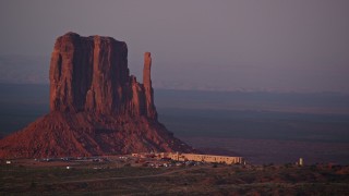 AX133_173E - 5.5K aerial stock footage of buttes, mesa and The View Hotel, Monument Valley, Utah, Arizona, sunset