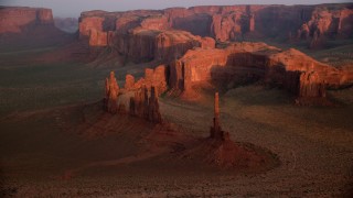 AX133_197 - 5.5K stock footage aerial video of Yei Be Chei Butte, Totem Pole Butte in Monument Valley, Utah, Arizona, sunset