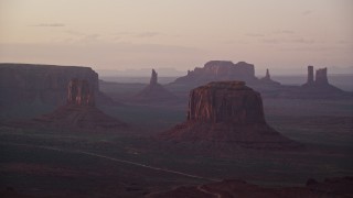 AX133_217E - 5.5K aerial stock footage of a view of West Mitten Butte, Merrick Butte, Monument Valley, Utah, Arizona, twilight