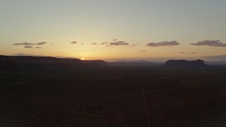AX134_001 - 5.5K aerial stock footage of flying by mesas in Monument Valley, Utah, Arizona, twilight