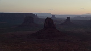 AX134_029E - 5.5K aerial stock footage of a view of several buttes in Monument Valley, Utah, Arizona, twilight