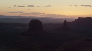 AX134_032 - 5.5K aerial stock footage of flying by Merrick Butte, West Mitten Butte in Monument Valley, Utah, Arizona, twilight